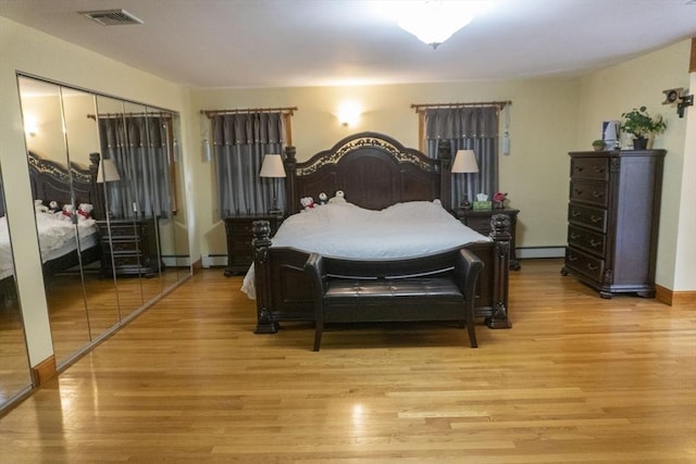118 Dudley Ln, Milton, MA 02186 - bedroom with a baseboard radiator and light wood-style floors