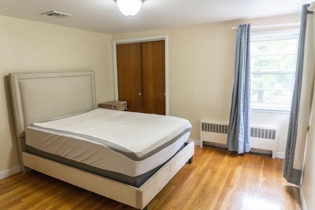 118 Dudley Ln, Milton, MA 02186 - bedroom featuring radiator heating unit, wood finished floors, baseboards, and a closet