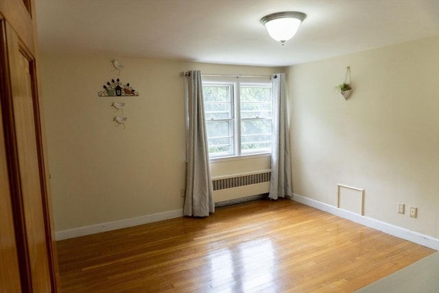 118 Dudley Ln, Milton, MA 02186 - spare room with radiator heating unit, light wood-style flooring, and baseboards