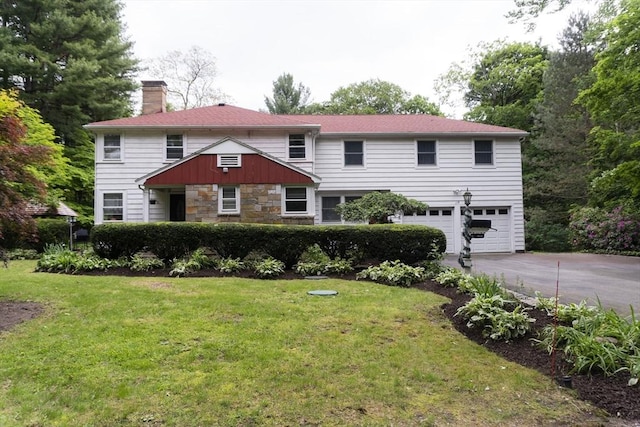 118 Dudley Ln, Milton, MA 02186 - view of front of house with a chimney, stone siding, an attached garage, driveway, and a front yard