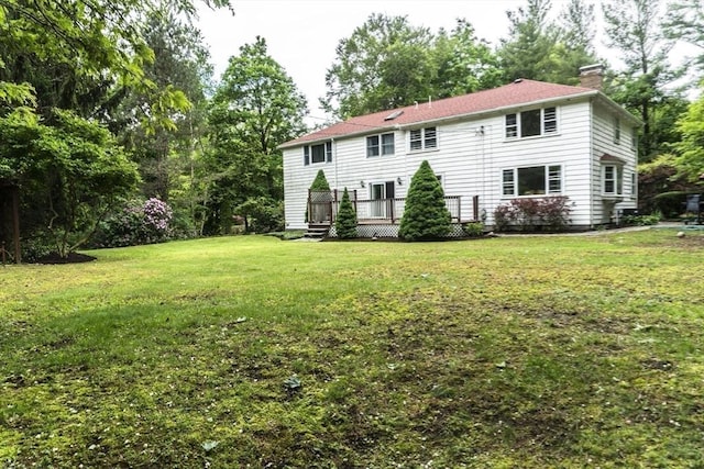118 Dudley Ln, Milton, MA 02186 - back of property featuring a chimney, a wooden deck, and a yard