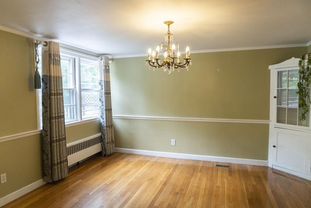 118 Dudley Ln, Milton, MA 02186 - spare room with radiator heating unit, a chandelier, wood finished floors, baseboards, and crown molding