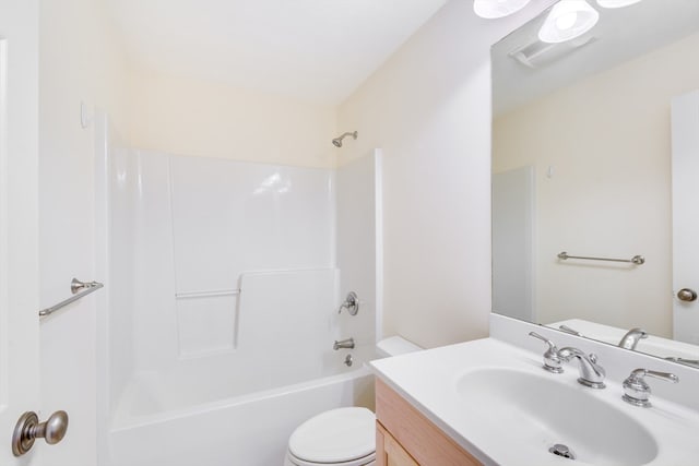 full bathroom featuring washtub / shower combination, vanity, and toilet