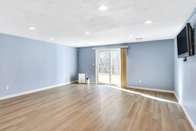 unfurnished room with light hardwood / wood-style floors and ornamental molding