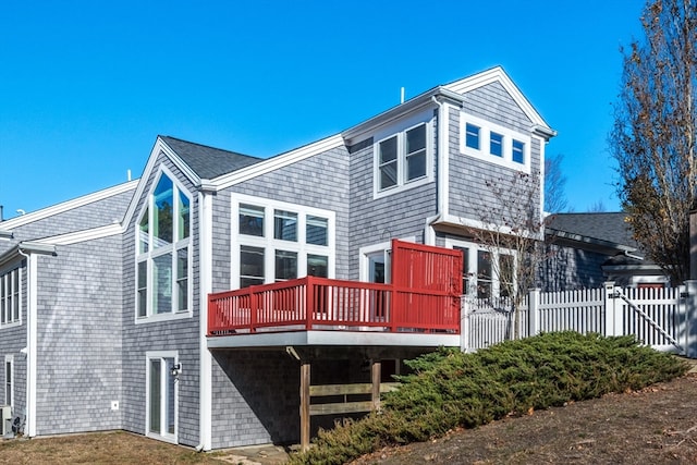 back of house with a wooden deck and cooling unit