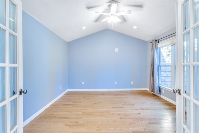 spare room with french doors, ceiling fan, light hardwood / wood-style flooring, and vaulted ceiling