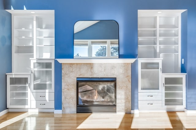 details featuring wine cooler, wood-type flooring, and a high end fireplace