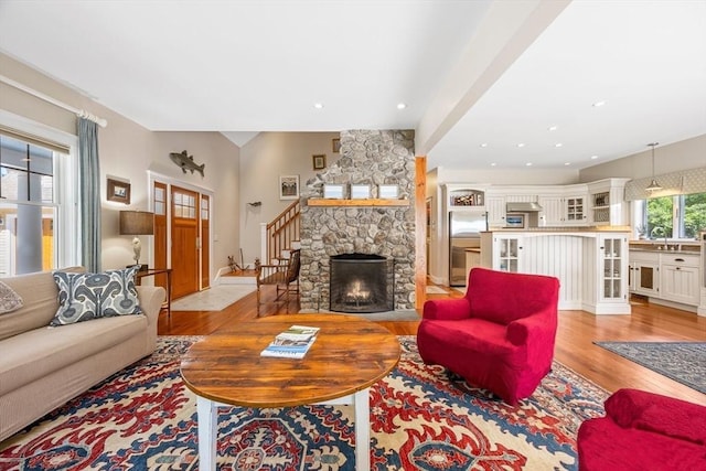 25 Richard Ln, Eastham, MA 02642 - living area with light wood finished floors, stairs, and a stone fireplace