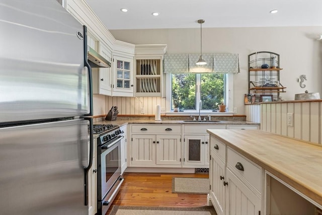 25 Richard Ln, Eastham, MA 02642 - kitchen with appliances with stainless steel finishes, light wood-style flooring, decorative light fixtures, white cabinetry, and recessed lighting