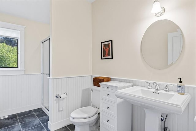 25 Richard Ln, Eastham, MA 02642 - bathroom with wainscoting, a shower stall, and tile patterned flooring