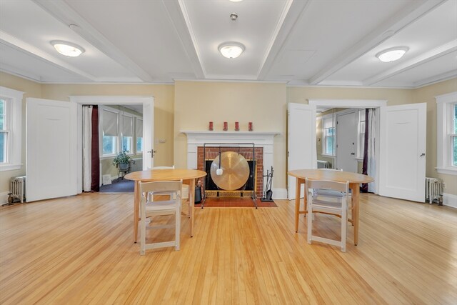 entryway with light hardwood / wood-style floors, radiator, and plenty of natural light