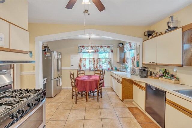 kitchen featuring decorative light fixtures, dishwashing machine, ceiling fan, gas range oven, and stainless steel fridge