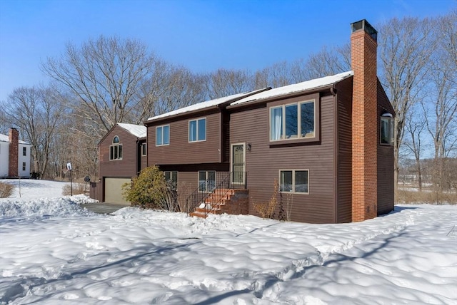 view of front of home with a chimney and an attached garage