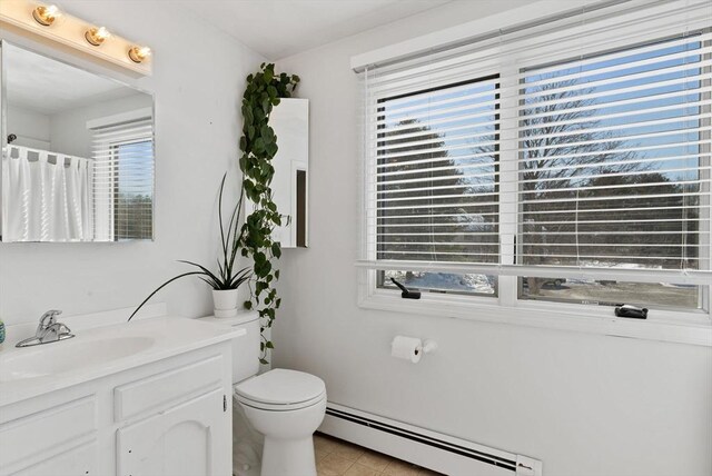 full bathroom with curtained shower, toilet, baseboard heating, vanity, and tile patterned floors