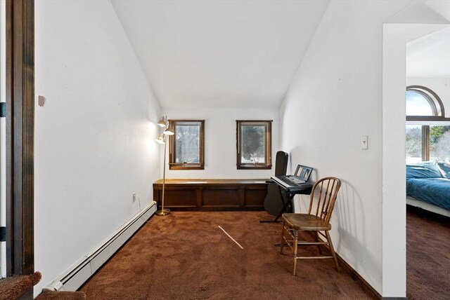 interior space featuring vaulted ceiling, dark carpet, a baseboard radiator, and baseboards