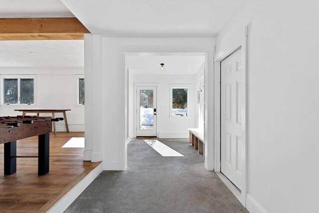 interior space featuring concrete flooring and baseboards