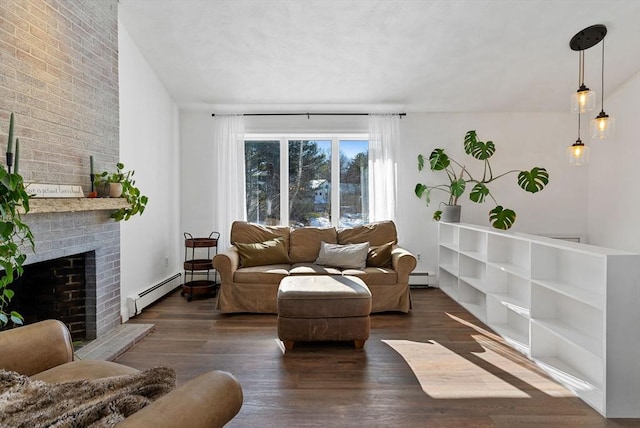 living room with a baseboard radiator, dark wood finished floors, and a brick fireplace