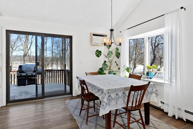 dining area featuring dark wood finished floors, vaulted ceiling, plenty of natural light, and a wall mounted AC