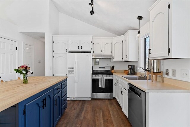 kitchen with hanging light fixtures, stainless steel appliances, blue cabinetry, white cabinetry, and a sink