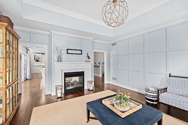 90 Chittenden Ln Unit 90, Cohasset, MA 02025 - living area featuring a decorative wall, crown molding, dark wood-style flooring, and a fireplace