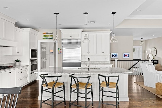 90 Chittenden Ln Unit 90, Cohasset, MA 02025 - kitchen featuring built in appliances, tasteful backsplash, white cabinets, a kitchen breakfast bar, and recessed lighting