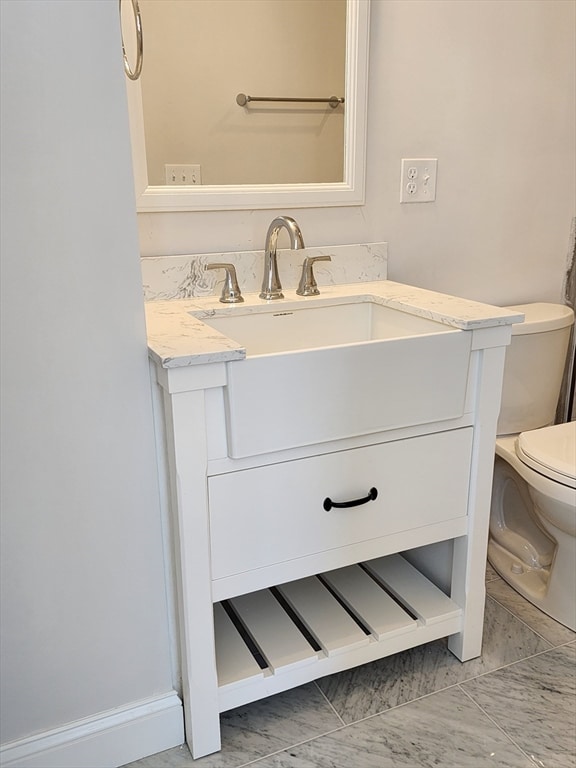 bathroom featuring vanity and toilet