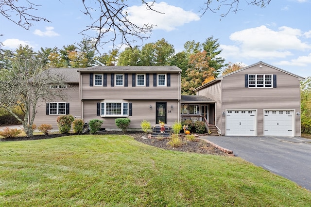 view of front of property featuring a front lawn and a garage