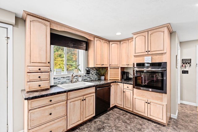 kitchen featuring sink, black dishwasher, oven, and light brown cabinetry