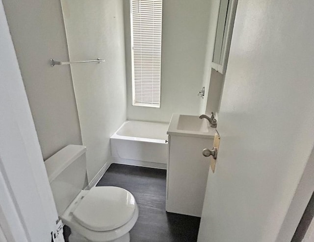 bathroom featuring toilet, wood finished floors, and vanity