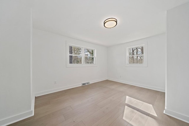 6 Raintree Rd, Dennis, MA 02639 - spare room with plenty of natural light, wood finished floors, and baseboards