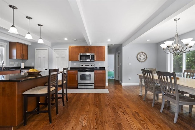 74 Glendale Rd, Braintree, MA 02184 - kitchen with stainless steel appliances, dark countertops, beam ceiling, dark wood-style floors, and a chandelier
