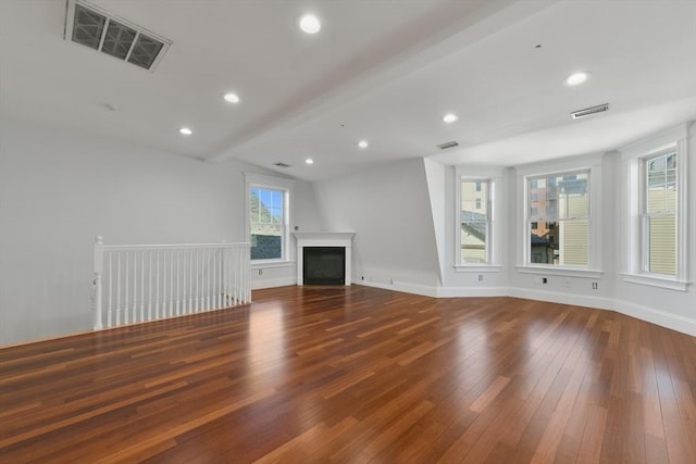 unfurnished living room with lofted ceiling with beams and dark hardwood / wood-style floors