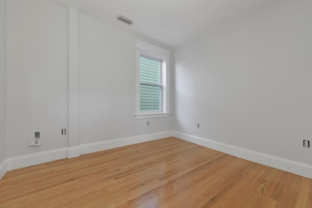 unfurnished room with light wood-type flooring