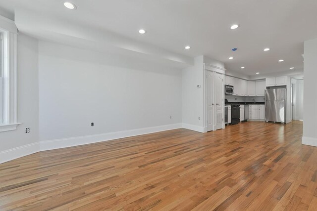 unfurnished living room with light hardwood / wood-style floors