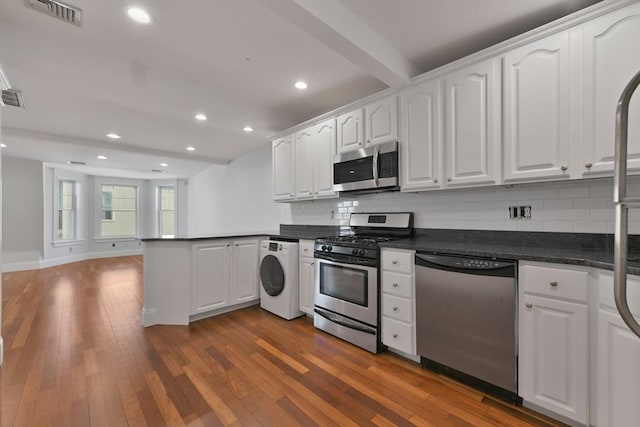 kitchen featuring washer / clothes dryer, stainless steel appliances, dark hardwood / wood-style flooring, beam ceiling, and white cabinetry