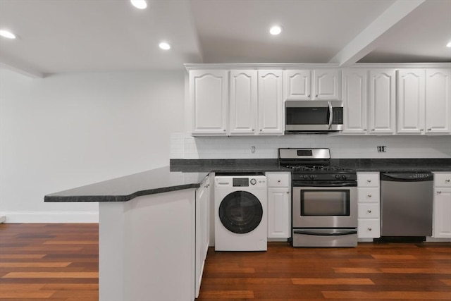 kitchen with kitchen peninsula, washer / dryer, appliances with stainless steel finishes, and white cabinets