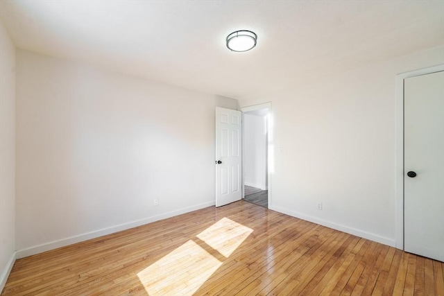 unfurnished bedroom with light wood-type flooring and baseboards