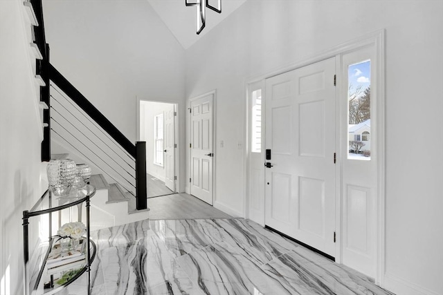 entrance foyer with high vaulted ceiling