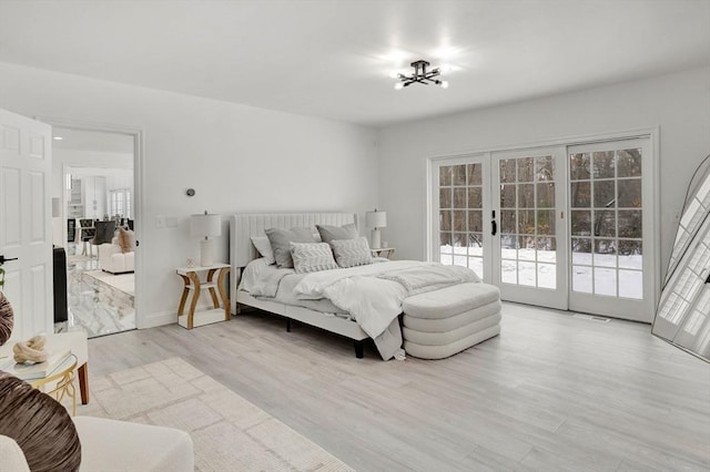 bedroom featuring light hardwood / wood-style flooring, access to exterior, and french doors