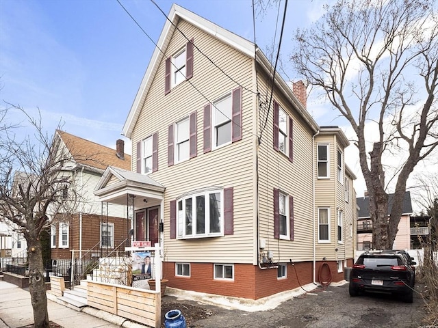 view of home's exterior featuring central AC and a chimney