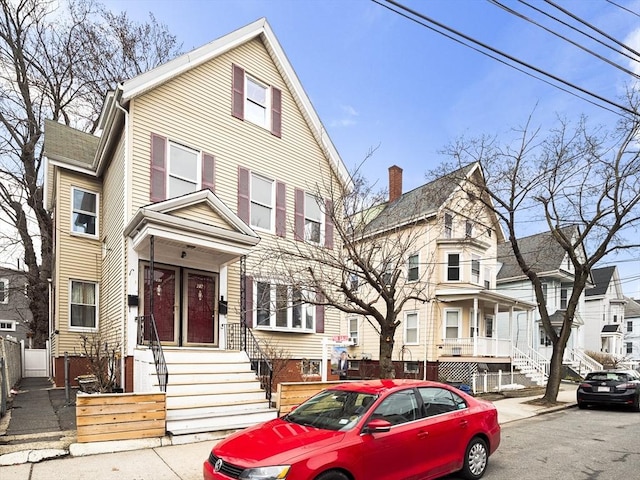 view of front of home featuring fence and a residential view