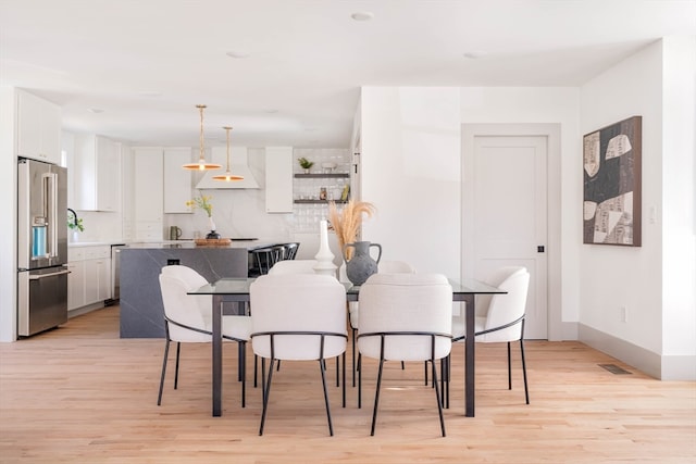 dining area featuring light wood-type flooring