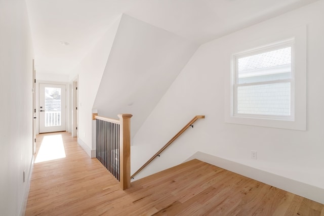 staircase featuring hardwood / wood-style flooring and vaulted ceiling