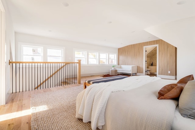 bedroom featuring light wood-type flooring and ensuite bathroom