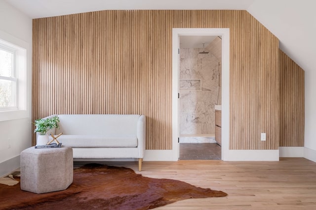 sitting room with hardwood / wood-style floors and lofted ceiling