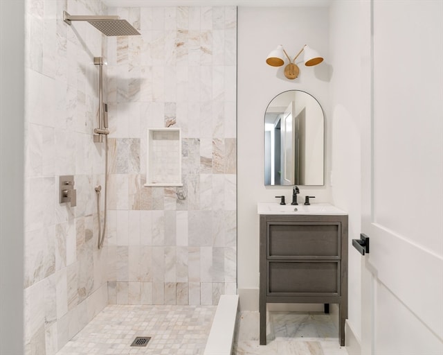 bathroom with vanity and tiled shower