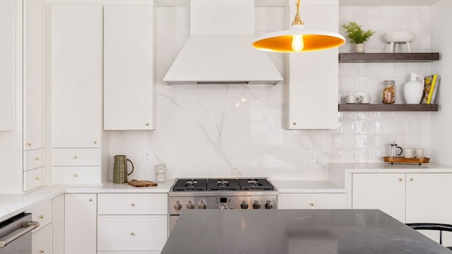 kitchen featuring premium range hood, backsplash, and white cabinets