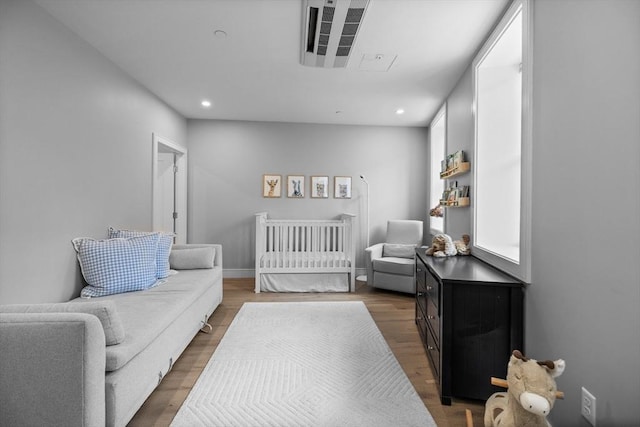 bedroom featuring recessed lighting, wood finished floors, and baseboards