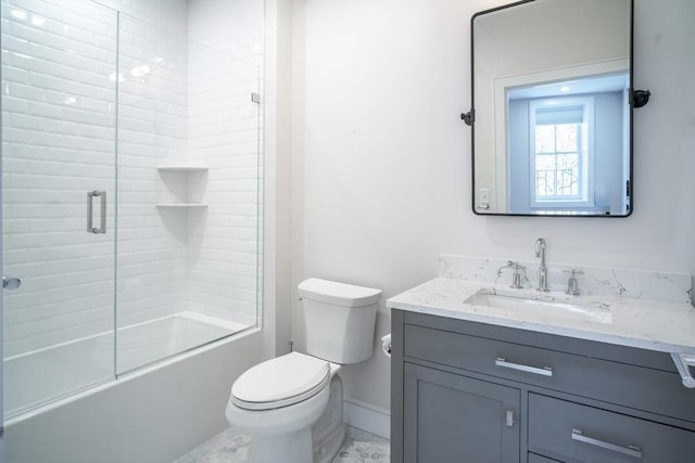 bathroom featuring baseboards, bath / shower combo with glass door, toilet, and vanity