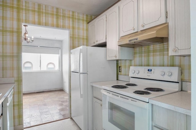 1 Charles St Unit W, Reading, MA 01867 - kitchen with white appliances, under cabinet range hood, wallpapered walls, light countertops, and a chandelier